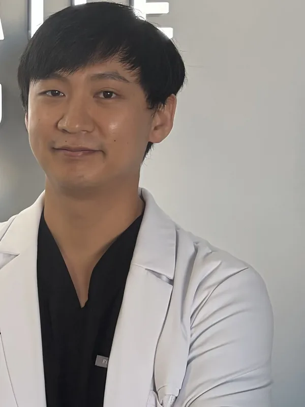 Dr. Ryan Oh, DDS, in his white coat at our Stamford office