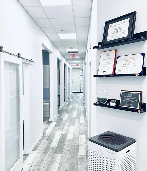 A bright hallway lined with framed credentials and awards