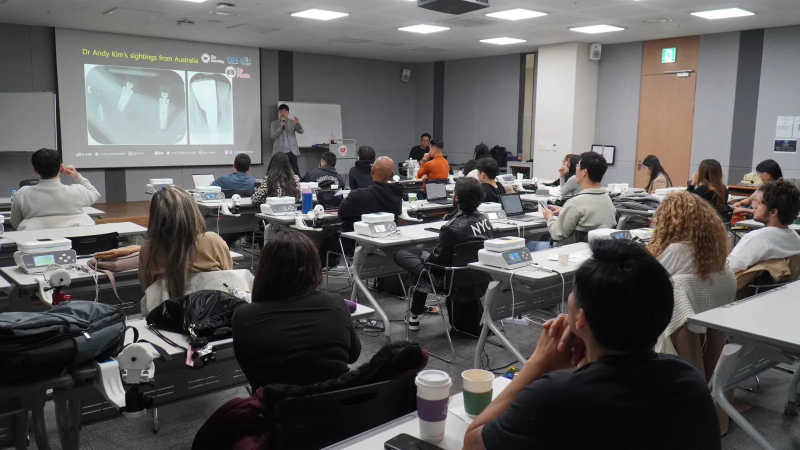 Dr. Kwon presenting an implant case to a room of dentists